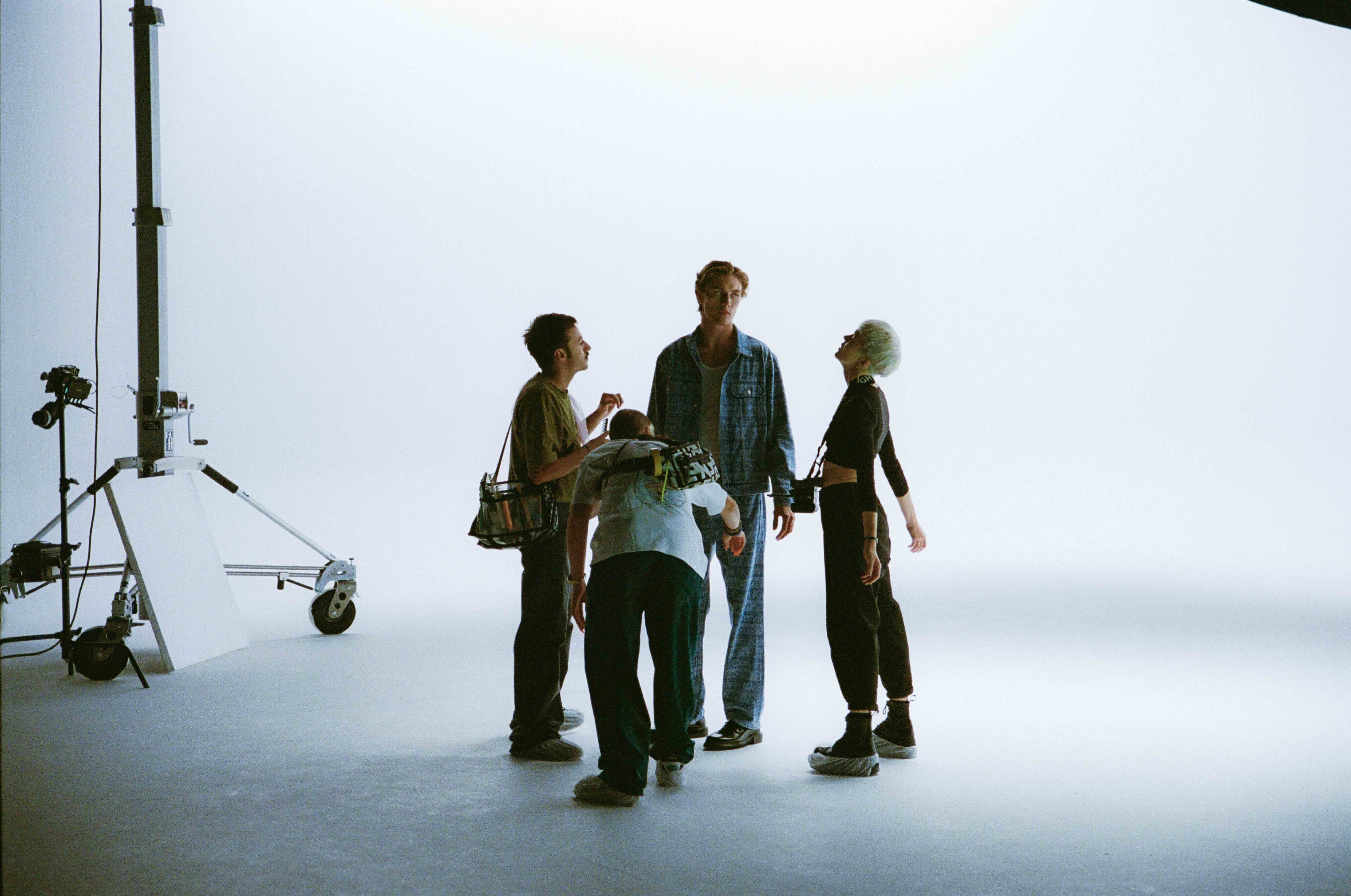 Movement Director is demonstrating international Model Lucky Blue Smith the movement for the next shot.