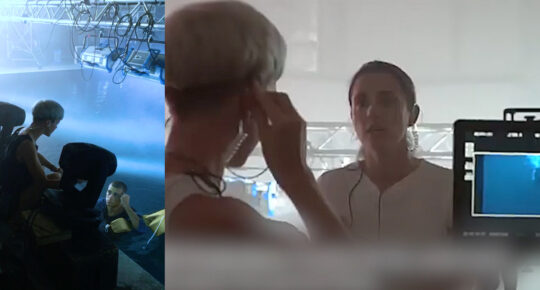 Marie Zechiel, movement director, guiding performers and collaborating with the crew during an underwater choreography production in a water tank studio setup.